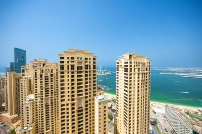 a view of a city with tall buildings and the ocean at Luxury 2BR - Stunning Marina View and JBR Beach in Dubai