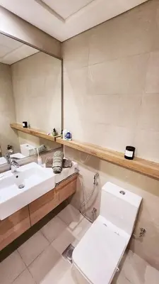 a bathroom with a toilet and a sink and a mirror at Charming Designed Apt - RIVIERA 26 Residence - Close to downtown in Dubai