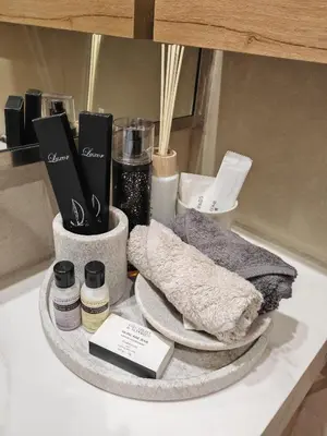 a counter with towels and other items on a shelf at Charming Designed Apt - RIVIERA 26 Residence - Close to downtown in Dubai