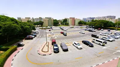 a parking lot with many cars parked in it at DRUVYA HOLIDAY HOMES, Building No 194, Street No,10 Discovery Gardens, Close to Al Furjan Metro 3 minutes walkable in Dubai
