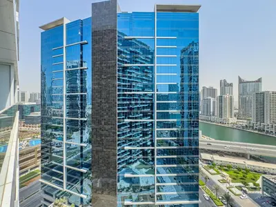 a view of a tall glass building in a city at Deluxe Studio Business Bay - Balcony City Skyline Views in Dubai