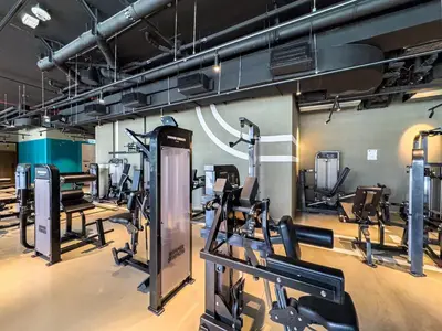 a gym with several treadmills and cardio machines at Deluxe Studio Business Bay - Balcony City Skyline Views in Dubai