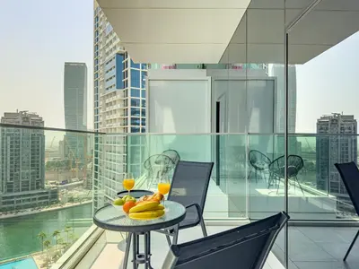 a table with fruit on it on a balcony at Deluxe Studio Business Bay - Balcony City Skyline Views in Dubai