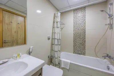 a bathroom with a sink and a tub and a shower at Exceptional 2BR with Marina Waterfront View in Dubai