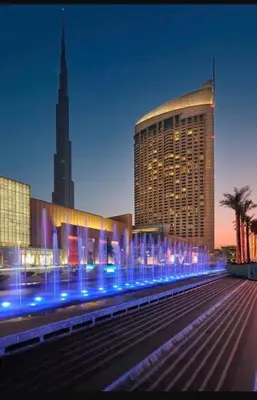 a large building with blue lights in front of it at Emaar Residenc Fashion Avenue - Sokoon in Dubai