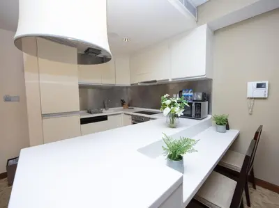 a kitchen with white cabinets and a white counter top at Emaar Residenc Fashion Avenue - Sokoon in Dubai