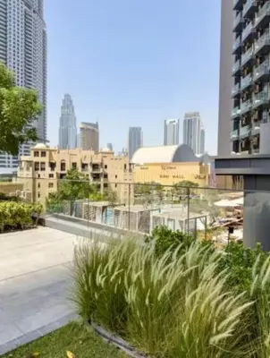 a view of a city with tall buildings and grass at Burj Royale 1BR - Close to Burj Khalifa and Dubai Mall in Dubai