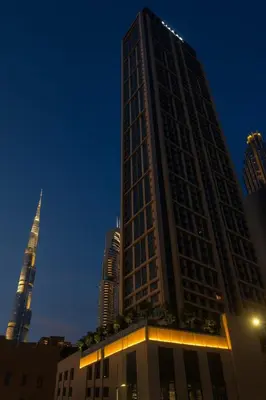 a tall building in a city at night at Burj Royale 1BR - Close to Burj Khalifa and Dubai Mall in Dubai