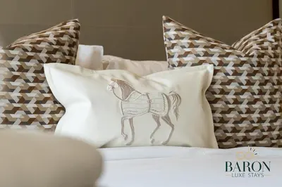 a drawing of a horse on a pillow on a bed at The Majestic in Dubai