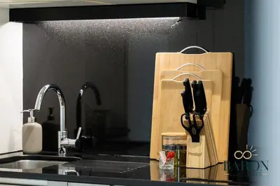 a kitchen counter with a cutting board with knives at The Majestic in Dubai