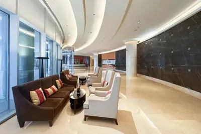 a living room with couches and chairs in a building at The Glamorous in Dubai