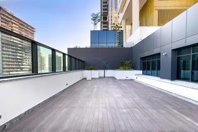 an empty balcony of a building with windows at 1BR with Maid's Room, Few Minutes Drive to Downtown Dubai, Burj Khalifa, Dubai Mall, Close to Parks and Crystal Lagoons - The Crest Tower C, Sobha Hartland by Deluxe Holiday Homes in Dubai