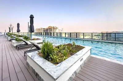 a swimming pool on the roof of a building at 1BR with Maid's Room, Few Minutes Drive to Downtown Dubai, Burj Khalifa, Dubai Mall, Close to Parks and Crystal Lagoons - The Crest Tower C, Sobha Hartland by Deluxe Holiday Homes in Dubai