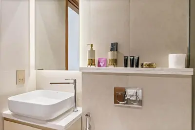 a bathroom with a white sink and a mirror at Brand New Stylish Unit near Circle Mall in Dubai