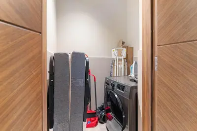 a laundry room with a washing machine in a room at Brand New Stylish Unit near Circle Mall in Dubai