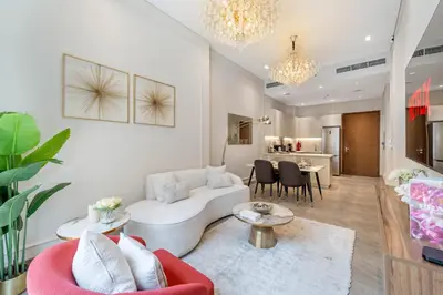 a living room with a white couch and a table at Brand New Stylish Unit near Circle Mall in Dubai