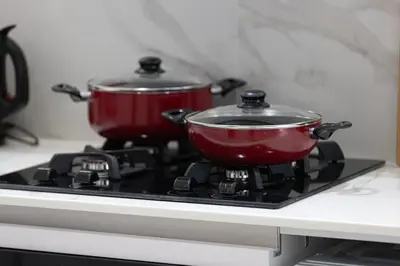 two pots sitting on top of a stove at Luxury Top Floor Apartment in JVC in Dubai