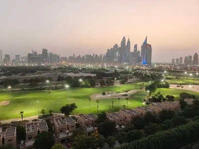 a view of a city at night with buildings at Newly Furnished Luxury 2BR - Perfect for a Family Getaway in Dubai
