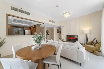 a living room with a table and a couch at Lux Upscale Living Walk to Dubai Mall in Dubai
