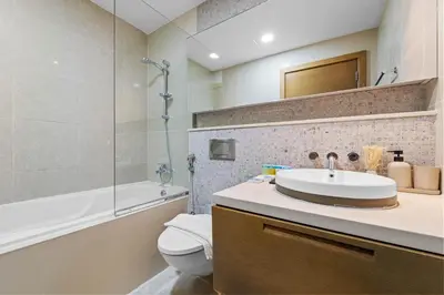 a bathroom with a sink and a toilet and a tub at Lux Upscale Living Walk to Dubai Mall in Dubai