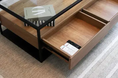 a coffee table with two remote controls in it at Stylish 4BD Villa Opposite Pool & Park in Dubai