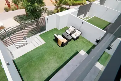 an overhead view of a lawn with two chairs and a couch at Stylish 4BD Villa Opposite Pool & Park in Dubai