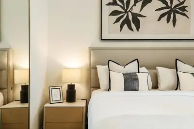 a bedroom with a large bed with white pillows at Stylish 4BD Villa Opposite Pool & Park in Dubai