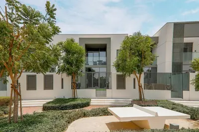 a building with a white bench in front of it at Stylish 4BD Villa Opposite Pool & Park in Dubai