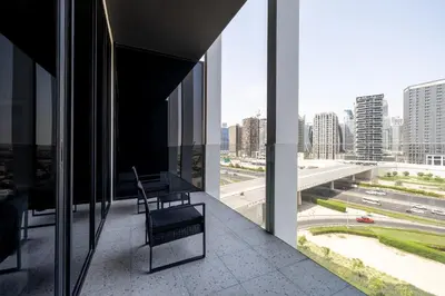 a chair on a balcony with a view of a city at Modern Studio, Burj Khalifa View, Upside Living in Dubai