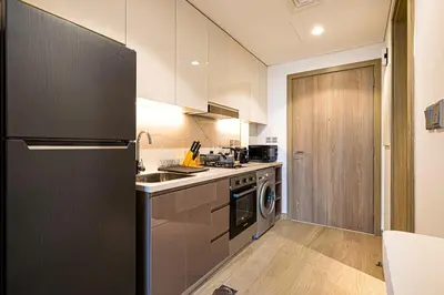 a kitchen with a refrigerator and a stove top oven at Studio in Azizi Riviera in Dubai