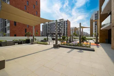 a courtyard in a city with tall buildings at Studio in Azizi Riviera in Dubai