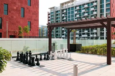 a chess game in a courtyard in front of a building at Studio in Azizi Riviera in Dubai