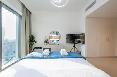 a bedroom with a large bed and a large window at Upscale 2BR with Burj Khalifa Views in Dubai