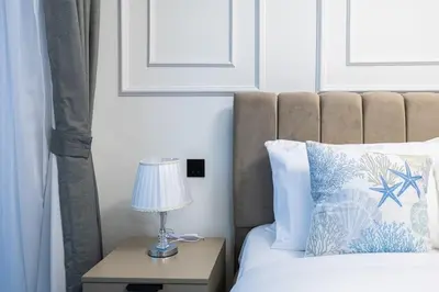 a bedroom with a bed with a lamp on a night stand at Chic Urban Escape Sobha Crest 1BR with Private Balcony in Dubai
