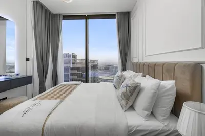 a bedroom with a bed and a large window at Chic Urban Escape Sobha Crest 1BR with Private Balcony in Dubai
