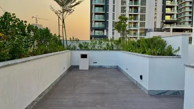 a walkway with a white box in the middle of a building at Chic Urban Escape Sobha Crest 1BR with Private Balcony in Dubai