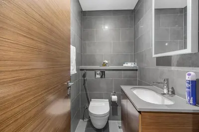 a bathroom with a toilet and a sink at Stylish 1BR Retreat in Sobha Crest with Balcony in Dubai