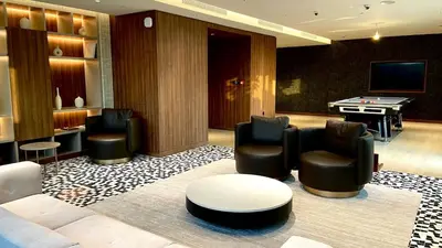 a living room with couches and a pool table at Stylish 1BR Retreat in Sobha Crest with Balcony in Dubai
