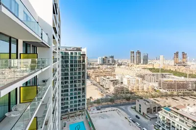 a view of a city from a building at Near Gadaf Community Park, Few Minutes Walk to Circle Mall, Short Drive to Dubai Miracle Garden and Butterfly Garden - Binghatti Amber, JVC by Deluxe Holiday Homes in Dubai