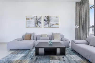 a living room with a couch and a coffee table at Parkview 2BR in Orchid, Damac Hills in Dubai