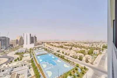 an aerial view of a city with a swimming pool at FAM Living Stylish Studio Apartment in Binghatti Azure JVC in Dubai