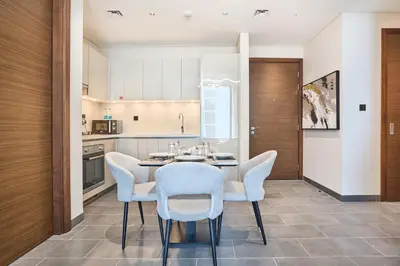 a kitchen with a dining room table and chairs at STAY BY LATINEM Luxury 2BR Holiday Home CC 911 Near Burj Khalifa in Dubai
