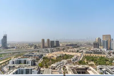 an aerial view of a city with tall buildings at Modern Studio with City Views Near Miracle Garden in Dubai