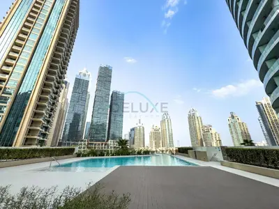 a view of the city from the rooftop pool of a building at High-Floor Seaview 2BR with Dubai Water Canal Panorama, Steps from Metro and Marina Beach, LIV Marina, Dubai Marina by Deluxe Holiday Homes in Dubai