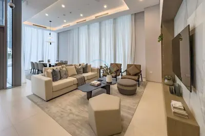 a living room with a couch and a table at High-Floor Seaview 2BR with Dubai Water Canal Panorama, Steps from Metro and Marina Beach, LIV Marina, Dubai Marina by Deluxe Holiday Homes in Dubai