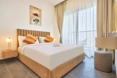 a bedroom with a large bed and a large window at STAY BY LATINEM Luxury 1BR Holiday Home CB 3113 Near Burj Khalifa in Dubai