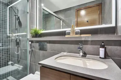 a bathroom with a sink and a shower at STAY BY LATINEM Luxury 1BR Holiday Home CB 3113 Near Burj Khalifa in Dubai