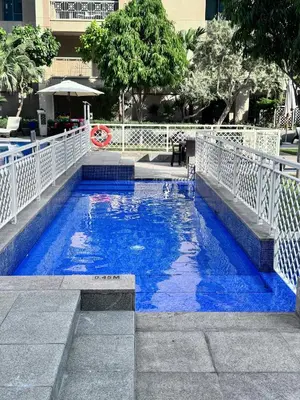 a swimming pool with blue water in a city at Luxury Apartment near Dubai Mall & Burj Khalifa at Emaar 29 Boulevard by Simply Comfort in Dubai