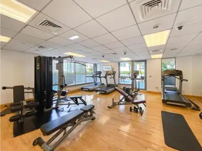 a gym with several treadmills and exercise bikes at Luxury Apartment near Dubai Mall & Burj Khalifa at Emaar 29 Boulevard by Simply Comfort in Dubai