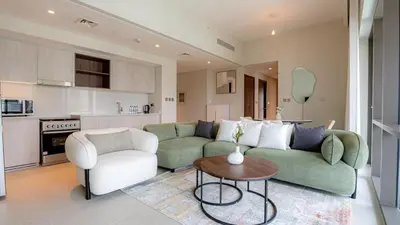 a living room with a couch and a table at Two Bedroom Apartment Down Town in Dubai